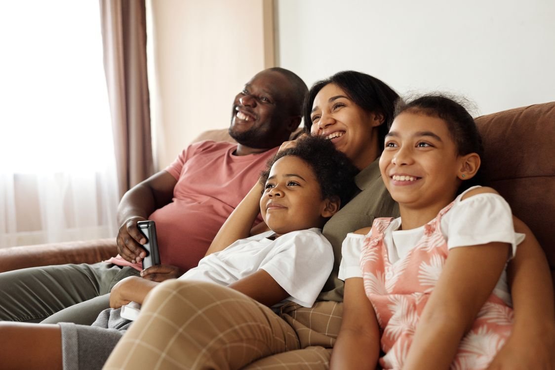 Stock photo of parents and children relaxing together at home